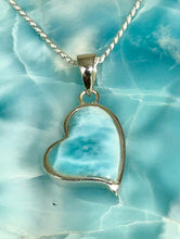 Load image into Gallery viewer, Heart-shaped larimar pendant on a chain against a light blue stone background